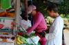 Tammy and the fruit seller at the NGC bus stop