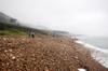 a relatively clean but still littered stretch of rocky beach