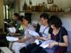 next photo: Inside farmhouse we gather to sing before orientation and work