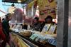 next photo: Tammy buying peanut, sesame, and kumquat cakes.