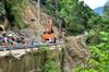 next photo: A-bao and Bernard inspect the road work