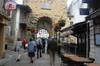 next photo: Family walking to the market via the old village main gate